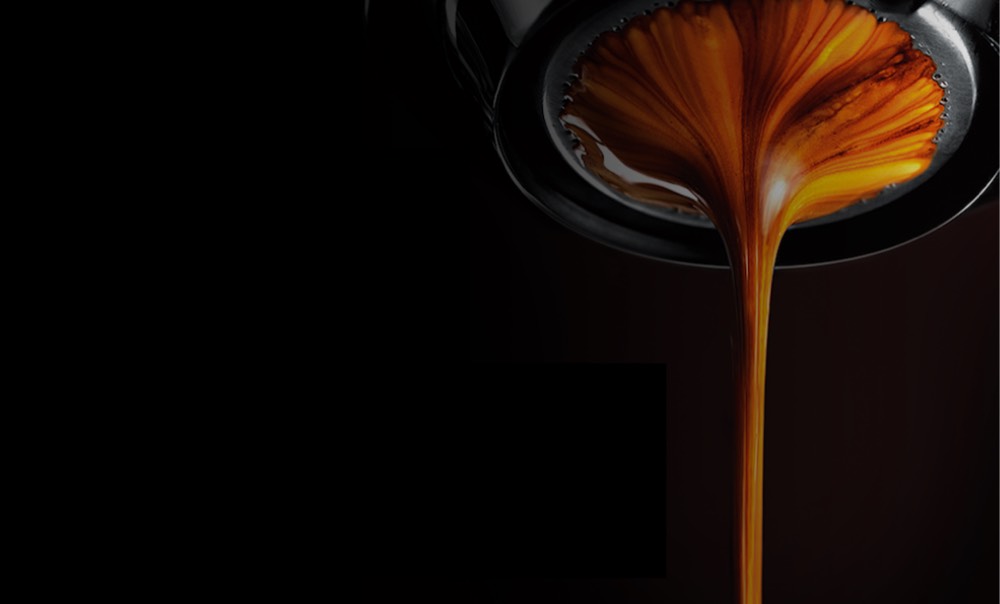 Close up of espresso extracting from a bottomless portafilter